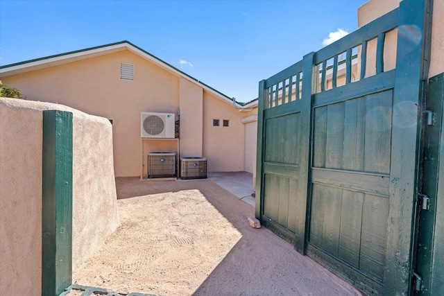 view of gate featuring central AC unit and ac unit