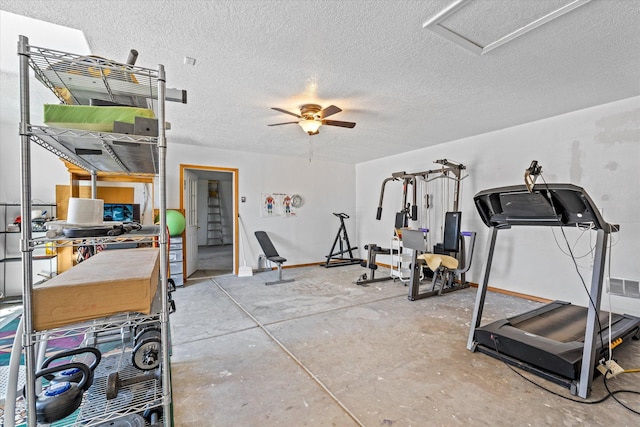 exercise room featuring ceiling fan and a textured ceiling