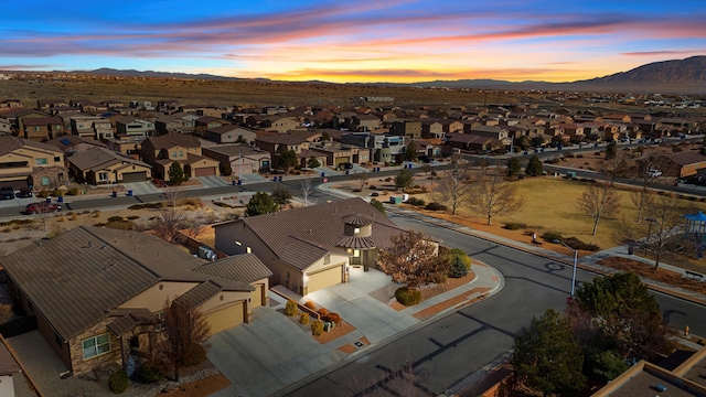 aerial view at dusk featuring a mountain view