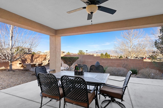 view of patio featuring a mountain view and ceiling fan