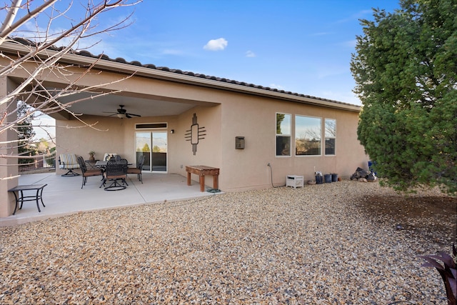 rear view of property featuring a patio and ceiling fan