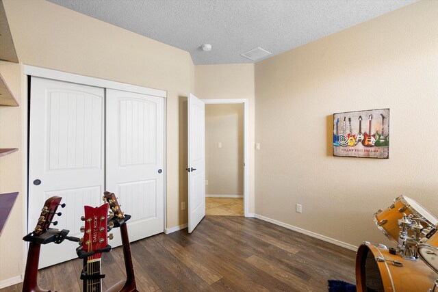 interior space featuring dark wood-type flooring and a textured ceiling