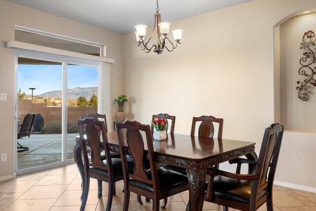 tiled dining room featuring a mountain view and a notable chandelier