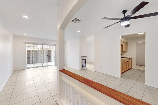 unfurnished room featuring light tile patterned floors and ceiling fan