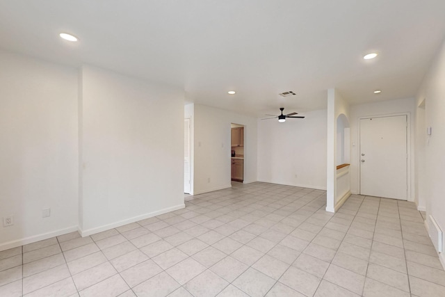 tiled empty room featuring ceiling fan