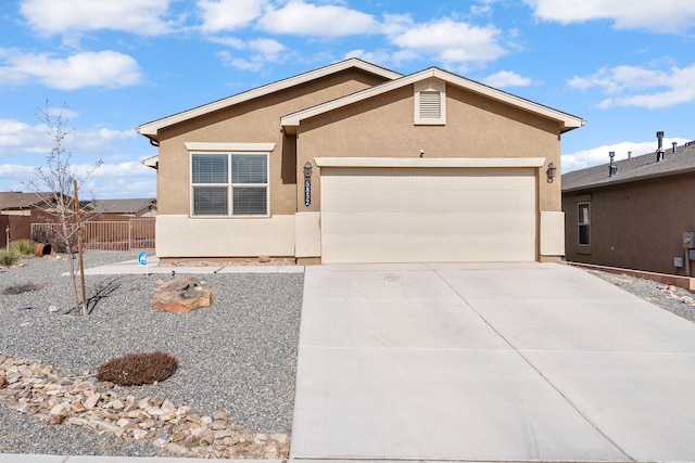 ranch-style house with a garage, fence, concrete driveway, and stucco siding