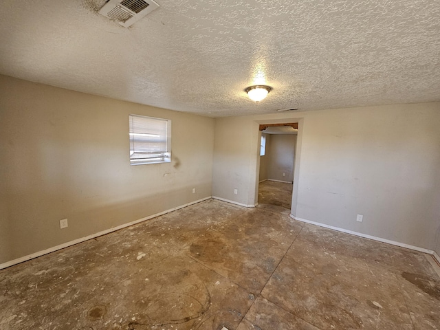 spare room featuring a textured ceiling