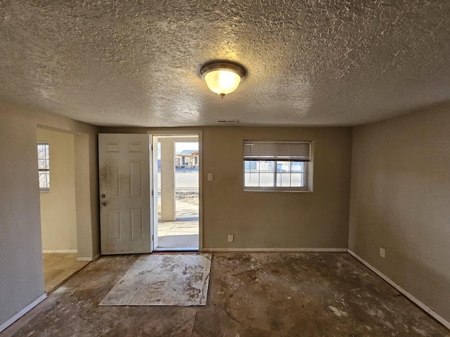 foyer entrance with a textured ceiling