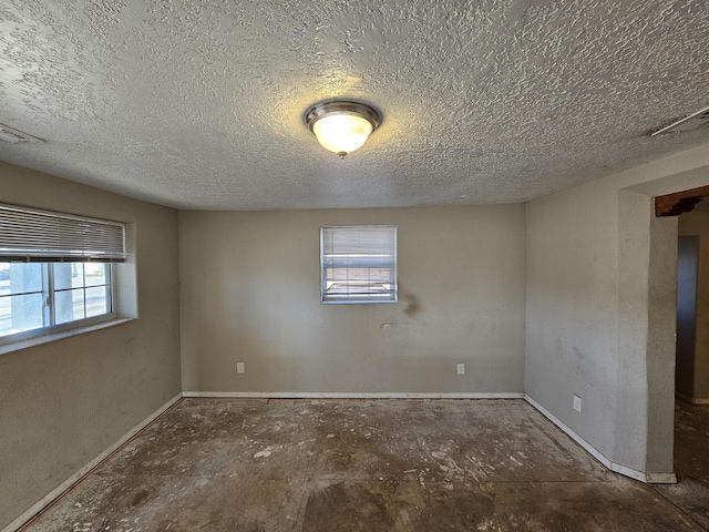 spare room featuring a textured ceiling