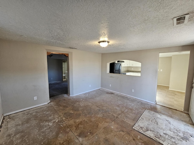 empty room featuring a textured ceiling