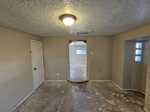 empty room with a textured ceiling