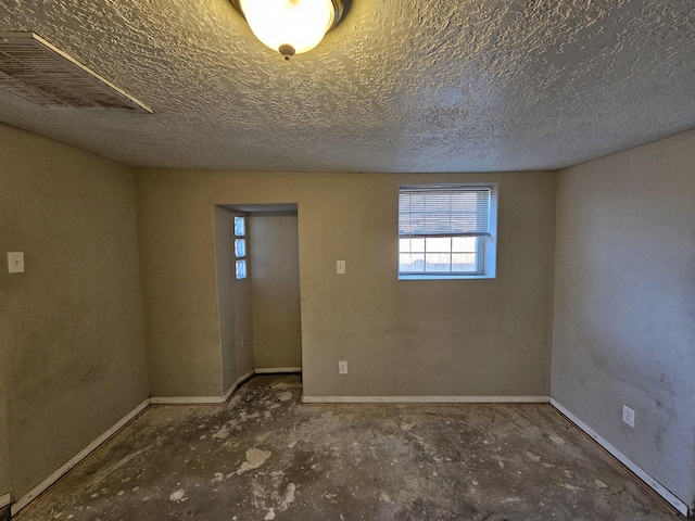 spare room featuring a textured ceiling