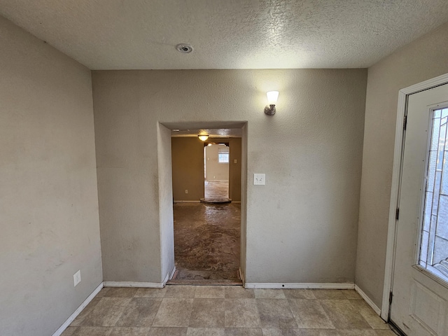 entryway with plenty of natural light and a textured ceiling