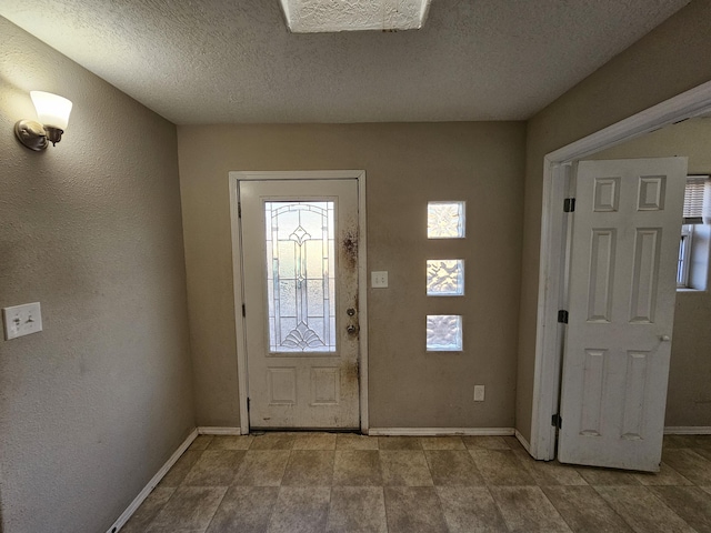 entryway with a textured ceiling