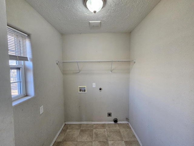 washroom featuring washer hookup, hookup for an electric dryer, hookup for a gas dryer, and a textured ceiling