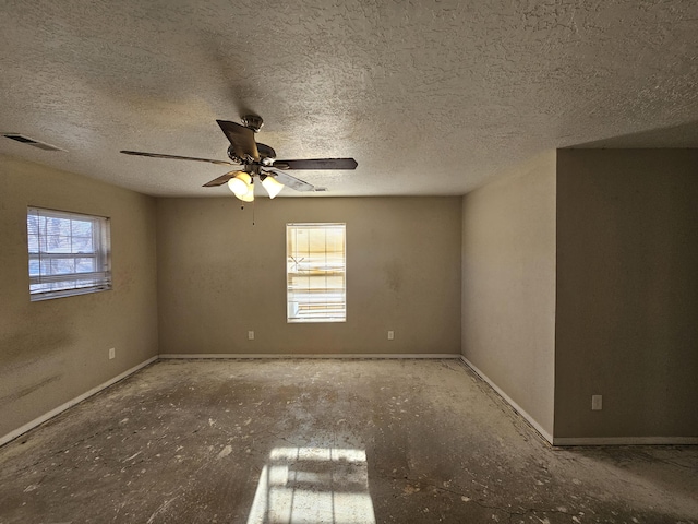 empty room featuring ceiling fan and a textured ceiling