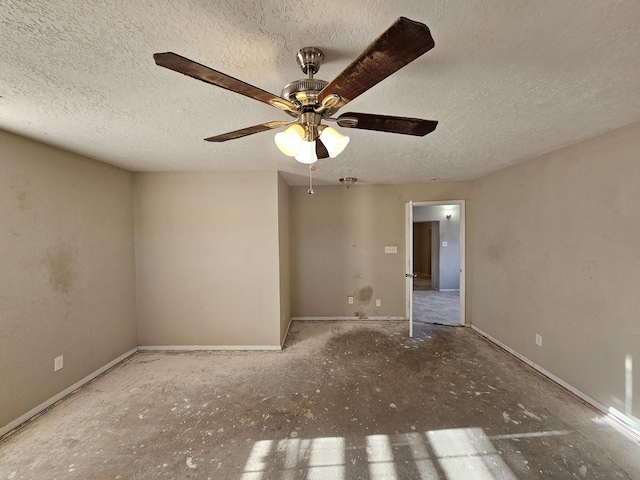 empty room featuring ceiling fan and a textured ceiling