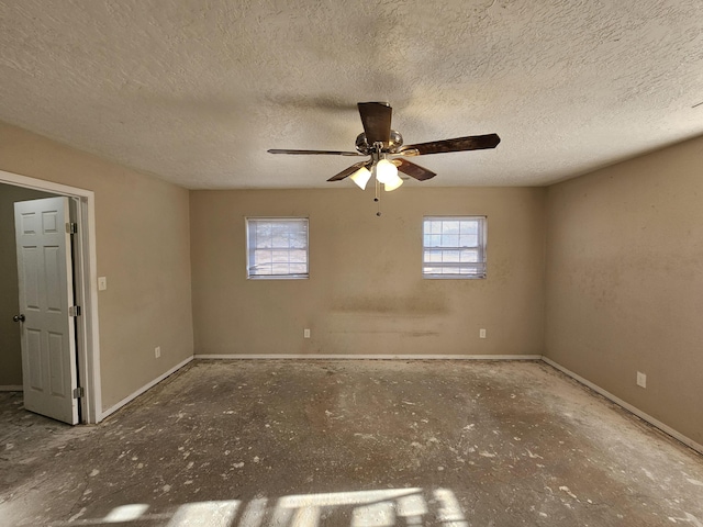 unfurnished room featuring ceiling fan and a textured ceiling