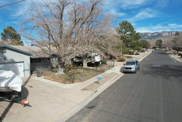 view of street featuring sidewalks, a mountain view, and curbs