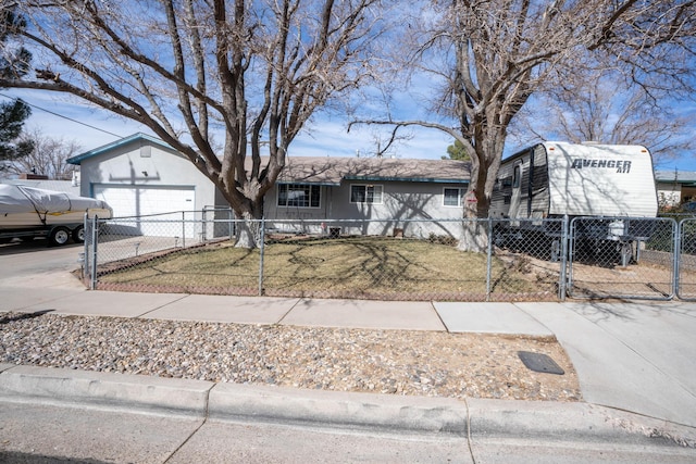 view of front of property featuring a fenced front yard, driveway, and a front lawn