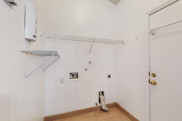 laundry area with gas dryer hookup, electric dryer hookup, cabinets, washer hookup, and light tile patterned flooring