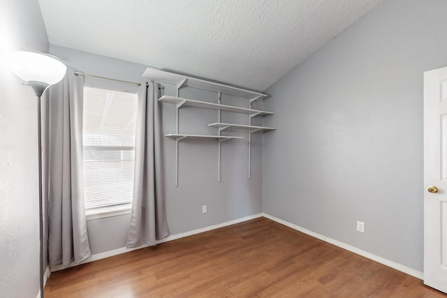 empty room featuring hardwood / wood-style floors and a textured ceiling