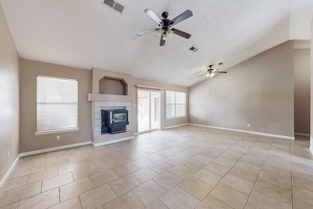 unfurnished living room featuring lofted ceiling, light tile patterned floors, a textured ceiling, and ceiling fan