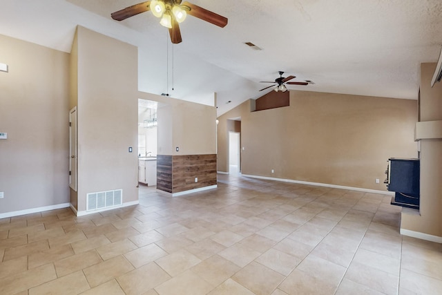 unfurnished living room featuring light tile patterned floors, vaulted ceiling, and ceiling fan