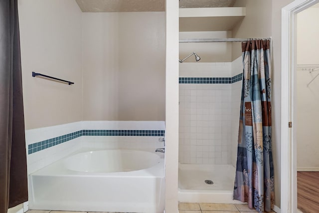 bathroom featuring tile patterned floors and independent shower and bath