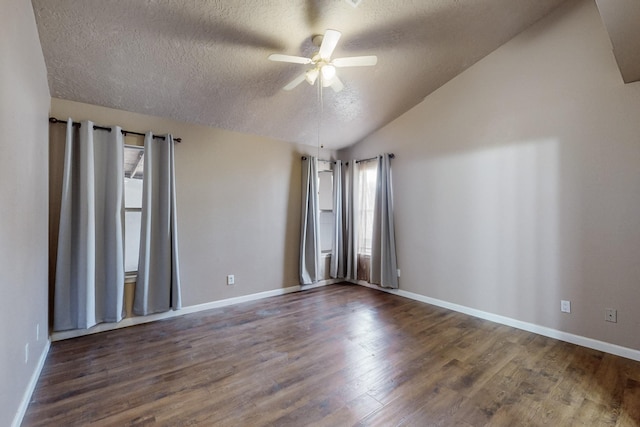 unfurnished room with dark wood-type flooring, vaulted ceiling, a textured ceiling, and ceiling fan