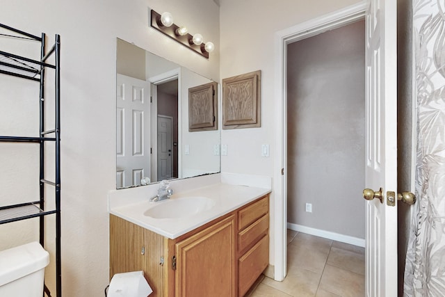 bathroom featuring vanity, tile patterned floors, and toilet