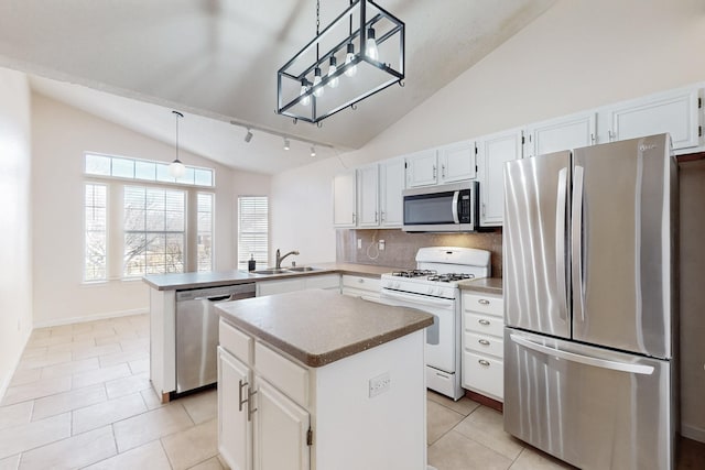 kitchen featuring stainless steel appliances, a kitchen island, pendant lighting, and kitchen peninsula