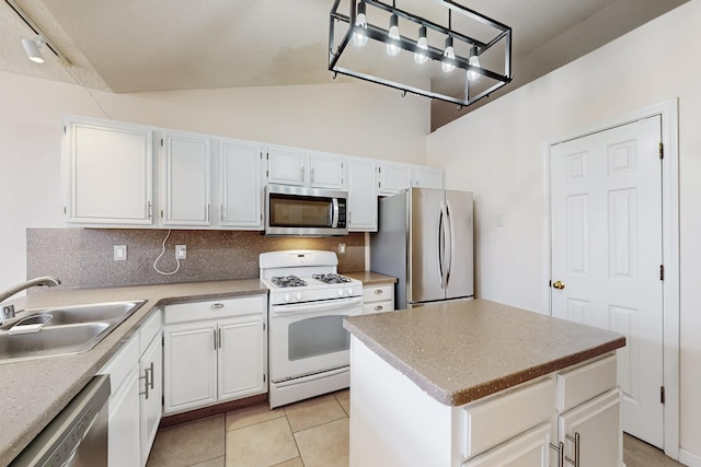 kitchen with stainless steel appliances, a kitchen island, and white cabinets