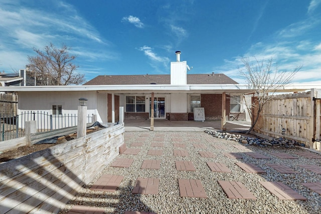 back of property with a patio