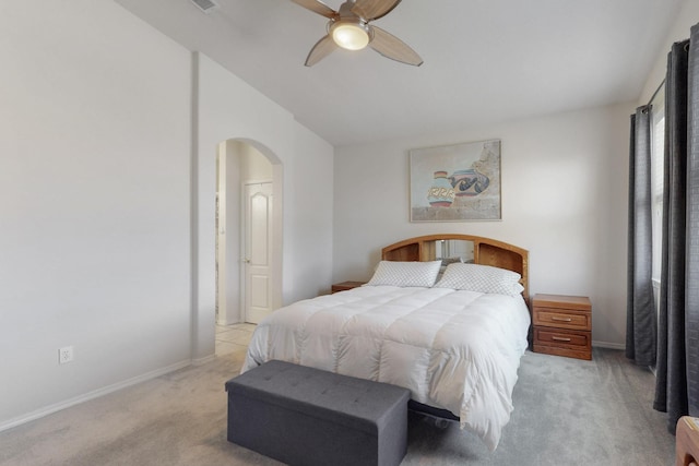 carpeted bedroom with ceiling fan and vaulted ceiling