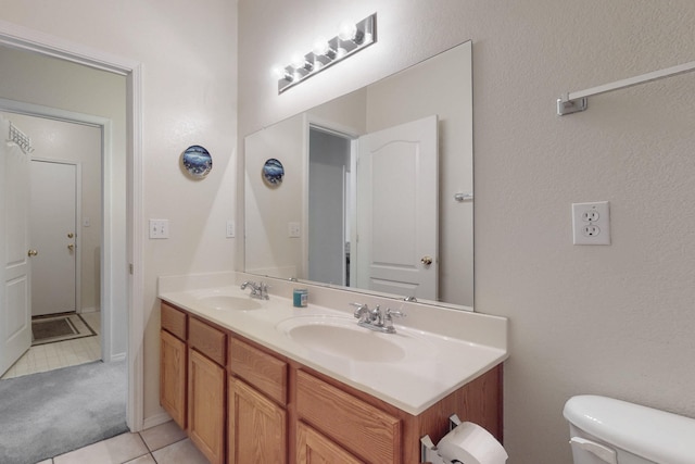 bathroom featuring vanity, tile patterned floors, and toilet