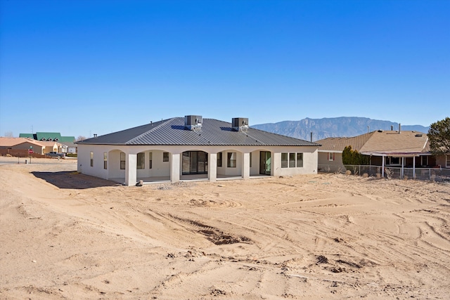 1145 15th St SE, Rio Rancho, NM 87124 - rear view of house featuring cooling unit and a mountain view