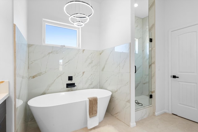 1145 15th St SE, Rio Rancho, NM 87124 - bathroom with vanity, independent shower and bath, tile walls, and a notable chandelier