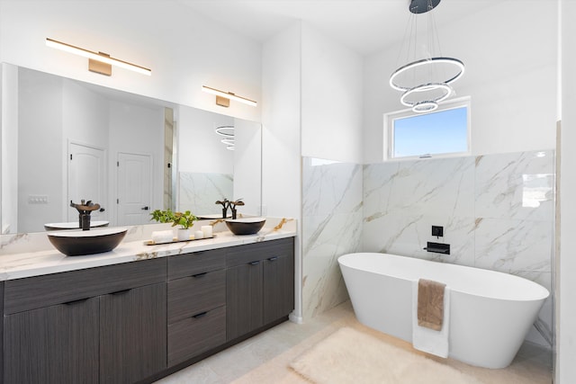1145 15th St SE, Rio Rancho, NM 87124 - bathroom with vanity, a tub to relax in, a chandelier, and tile walls