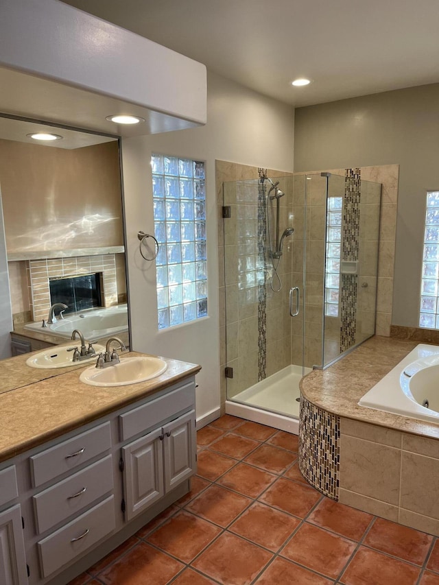 bathroom featuring tile patterned flooring, plus walk in shower, and vanity