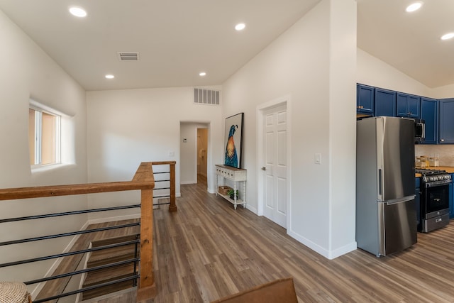 hall featuring lofted ceiling and dark hardwood / wood-style floors