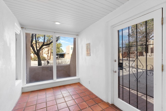 unfurnished sunroom featuring wood ceiling