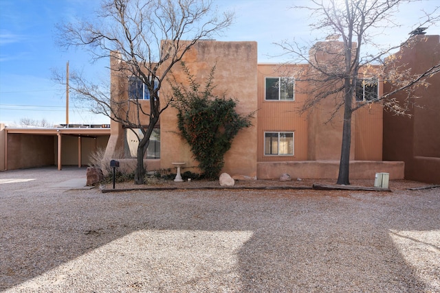 view of side of property with a carport