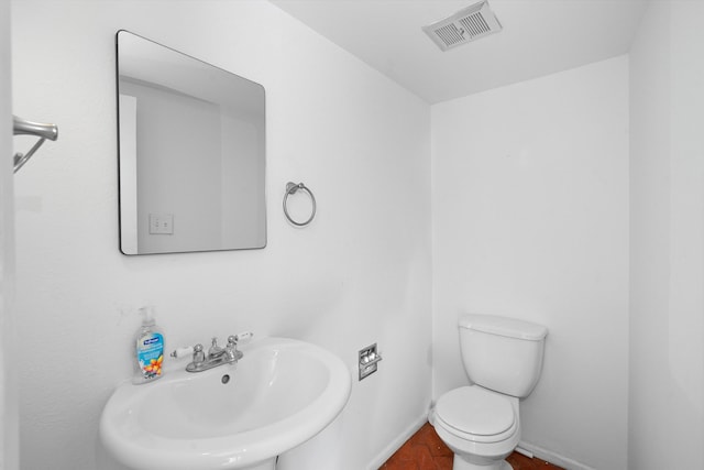 bathroom featuring sink and toilet