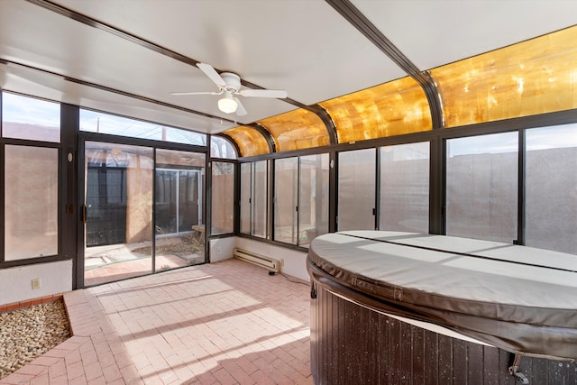 unfurnished sunroom with ceiling fan