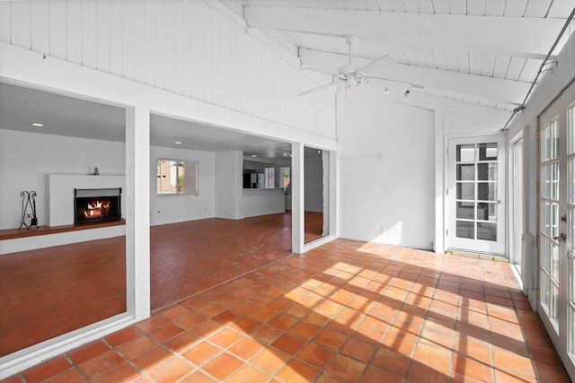 unfurnished sunroom with vaulted ceiling with beams, wooden ceiling, ceiling fan, and french doors