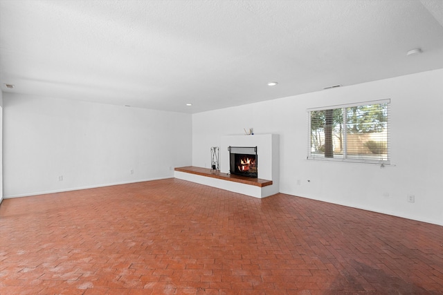 unfurnished living room with a textured ceiling