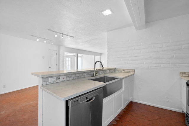 kitchen with sink, stainless steel dishwasher, kitchen peninsula, and white cabinets