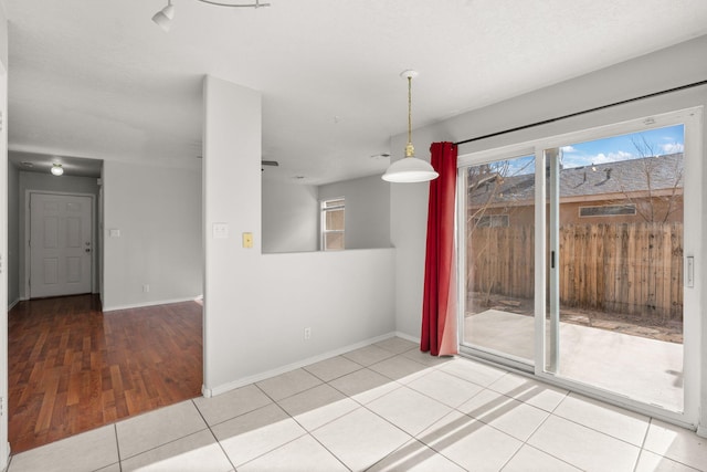 unfurnished dining area with light tile patterned floors