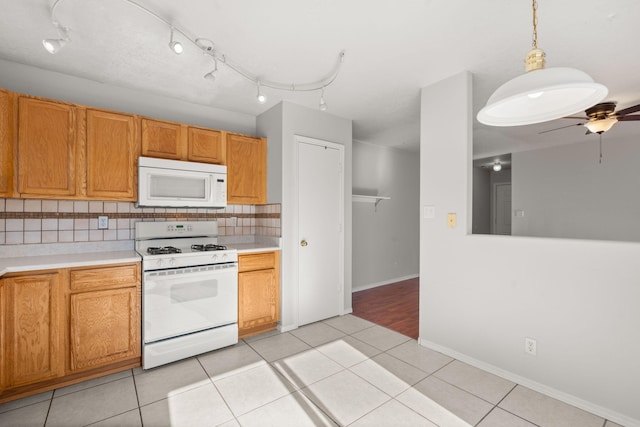 kitchen featuring backsplash, white appliances, ceiling fan, light tile patterned flooring, and pendant lighting